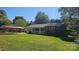 This brick home features a welcoming front porch and convenient carport, all set on a green lawn at 133 Pine State Rd, Troutman, NC 28166