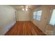 Bright living room boasts hardwood floors, neutral walls, large window, and ceiling fan at 133 Pine State Rd, Troutman, NC 28166