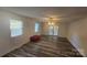 Spacious living room with wood-look floors, ceiling fan, and natural light from multiple windows at 133 Pine State Rd, Troutman, NC 28166