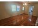 Cozy living room featuring hardwood floors, neutral walls, a ceiling fan, and natural light at 133 Pine State Rd, Troutman, NC 28166