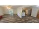 Open-concept living area with wood-look floors connecting to the kitchen with lots of natural light at 133 Pine State Rd, Troutman, NC 28166