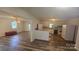 Open-concept living space with wood-look flooring, seamlessly connecting to the kitchen area at 133 Pine State Rd, Troutman, NC 28166