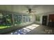 Bright sunroom filled with natural light from numerous windows overlooking the yard at 133 Pine State Rd, Troutman, NC 28166
