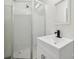 Bright bathroom featuring a modern white vanity, a sleek black faucet, and a glass-enclosed shower stall at 1417 W Monroe St, Salisbury, NC 28144