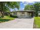 Charming single-story home featuring a covered carport and a large concrete driveway at 1417 W Monroe St, Salisbury, NC 28144