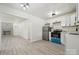 Modern kitchen with stainless steel appliances, white cabinets, and adjacent living area at 1417 W Monroe St, Salisbury, NC 28144