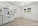Clean kitchen featuring white cabinets, modern fixtures, lots of natural light and wood-look flooring at 1417 W Monroe St, Salisbury, NC 28144