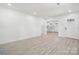 Spacious, open-concept living room with light colored walls and wood-look flooring at 1417 W Monroe St, Salisbury, NC 28144
