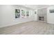 Open living room with a charming brick fireplace, lots of light and wood-look flooring at 1417 W Monroe St, Salisbury, NC 28144