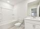 Bright and minimalist bathroom featuring a combined bathtub and shower, toilet, and a vanity with storage at 1421 Wildflower St, Newton, NC 28658