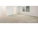 Comfortable bedroom with a plush carpet, a window, and an adjoining doorway at 1421 Wildflower St, Newton, NC 28658