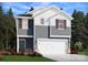 Charming two-story home with a two-car garage, gray horizontal siding, and lovely landscaping at 1421 Wildflower St, Newton, NC 28658
