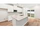 Modern kitchen featuring white cabinets, a granite island, and stainless steel appliances at 1421 Wildflower St, Newton, NC 28658