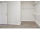 Spacious walk-in closet with white walls, carpeted floor, and wire shelving for maximum storage and organization at 145 Satchel Ct, Mooresville, NC 28115