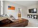 Cozy bonus room showcases a leather sofa, with a peek into the en suite bathroom at 15714 Laurel Oak Cres, Davidson, NC 28036