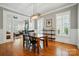 Dining room with hardwood floors, large windows, and views into the living area, perfect for entertaining at 15714 Laurel Oak Cres, Davidson, NC 28036