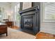 Close-up of the fireplace, highlighting the millwork, hearth and surrounding hardwood floors at 15714 Laurel Oak Cres, Davidson, NC 28036