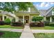 Charming home featuring a quaint front porch, colorful landscaping, and a neatly maintained lawn at 15714 Laurel Oak Cres, Davidson, NC 28036