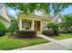 Charming home featuring a quaint front porch, colorful landscaping, and a neatly maintained lawn at 15714 Laurel Oak Cres, Davidson, NC 28036
