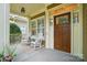 Inviting front porch with rocking chairs, offering a cozy and relaxing outdoor space at 15714 Laurel Oak Cres, Davidson, NC 28036