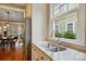Cozy kitchen sink area with stainless steel appliances, granite counters and view to the back yard at 15714 Laurel Oak Cres, Davidson, NC 28036