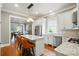 Open kitchen with granite countertops, stainless appliances, and barstool seating that connects to the dining area at 15714 Laurel Oak Cres, Davidson, NC 28036