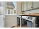 Laundry room featuring a large window and newer washer and dryer at 15714 Laurel Oak Cres, Davidson, NC 28036