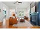 Bright living room with a fireplace, hardwood floors, and abundant natural light through shuttered windows at 15714 Laurel Oak Cres, Davidson, NC 28036