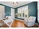 Stylish home office with a ceiling fan, natural light, and a comfortable chair for a productive work environment at 15714 Laurel Oak Cres, Davidson, NC 28036
