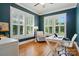 Bright home office featuring natural light, a ceiling fan, and modern furnishings for a comfortable workspace at 15714 Laurel Oak Cres, Davidson, NC 28036