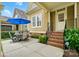Outdoor patio space with seating, accented by brick steps and vibrant landscaping, perfect for entertaining at 15714 Laurel Oak Cres, Davidson, NC 28036