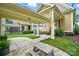 Charming covered patio with seating area, complemented by well-manicured landscaping and a classic design at 15714 Laurel Oak Cres, Davidson, NC 28036