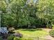Expansive backyard featuring lush lawn, mature trees, and a fenced perimeter at 15831 Breton Brook St, Huntersville, NC 28078