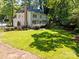 Spacious backyard with lush green lawn and mature trees offering privacy and shade at 15831 Breton Brook St, Huntersville, NC 28078