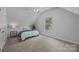 Inviting bedroom featuring soft blue bedding, a bedside table, and a sunlit window at 15831 Breton Brook St, Huntersville, NC 28078