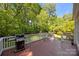 Back deck with a grill and seating area surrounded by lush greenery at 15831 Breton Brook St, Huntersville, NC 28078