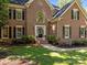 Stately brick home with well-manicured landscaping and charming entrance at 15831 Breton Brook St, Huntersville, NC 28078