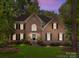 Charming brick home with manicured lawn, black shutters, and a welcoming front entrance at 15831 Breton Brook St, Huntersville, NC 28078