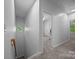 Upstairs hallway featuring natural light and access to a home office space at 15831 Breton Brook St, Huntersville, NC 28078