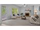 Bright living room with plush carpeting, fireplace, and ample natural light from large windows at 15831 Breton Brook St, Huntersville, NC 28078