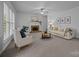Inviting living room featuring a fireplace, plush seating, and large windows for natural light at 15831 Breton Brook St, Huntersville, NC 28078