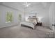 Bright main bedroom with tray ceiling, ceiling fan and large windows at 15831 Breton Brook St, Huntersville, NC 28078