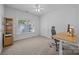 Well-lit office with a large window, built-in shelving and neutral carpet at 15831 Breton Brook St, Huntersville, NC 28078