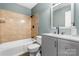 This updated bathroom features modern fixtures and a combined shower and tub at 160 17Th Street Nw Pl, Hickory, NC 28601