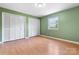 Bright bedroom with wood floors, green walls, and large closet at 160 17Th Street Nw Pl, Hickory, NC 28601