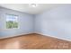 This cozy bedroom has wood floors and a window bringing in natural light at 160 17Th Street Nw Pl, Hickory, NC 28601