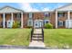 Two-story brick townhomes with well-manicured lawn and concrete walkway and steps at 160 17Th Street Nw Pl, Hickory, NC 28601
