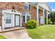 Brick two-story townhome with white door trim, bay window, and landscaped yard at 160 17Th Street Nw Pl, Hickory, NC 28601