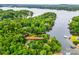 Aerial view of a lakeside home with mature trees and water views at 18028 Broken Woods Rd, Charlotte, NC 28278