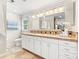 Well-lit bathroom with double sinks and a tiled countertop at 18028 Broken Woods Rd, Charlotte, NC 28278
